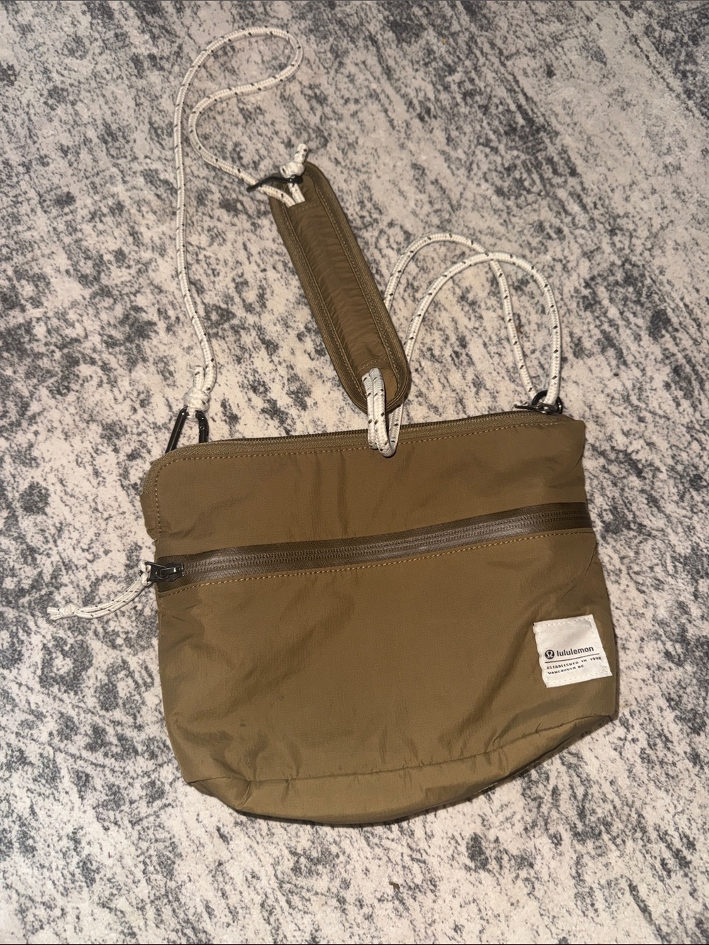 Lululemon Patch Logo Crossbody Bag 2.5L Bold Taupe color.